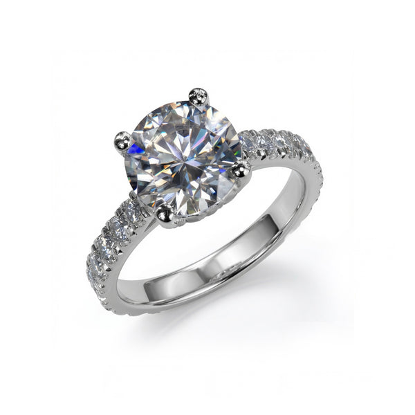 A silver-tone diamond engagement ring featuring a round-cut center stone in a four-prong setting, with a pavé band accented by small round diamonds, shown on a clean white background.