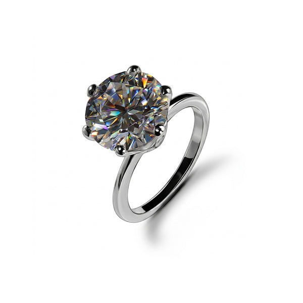 A round brilliant-cut gemstone solitaire ring in a polished silver-tone setting, shown on a clean white background with a soft shadow.
